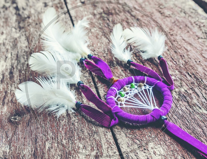 A handmade dreamcatcher with bright feathers