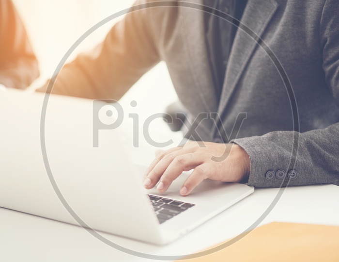 Businessman Or Business Project Manager Hands Working On Laptop  At Office Desk