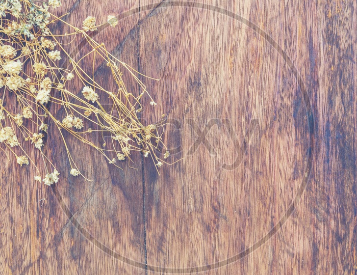 Summer dried flowers on vintage wooden background