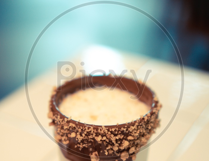 Cappuccino with chocolate caramel in cafe, table cafe