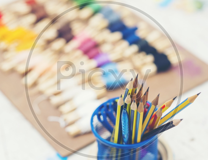 Colorful embroidery thread Bokeh With Pencils  in a Bowl