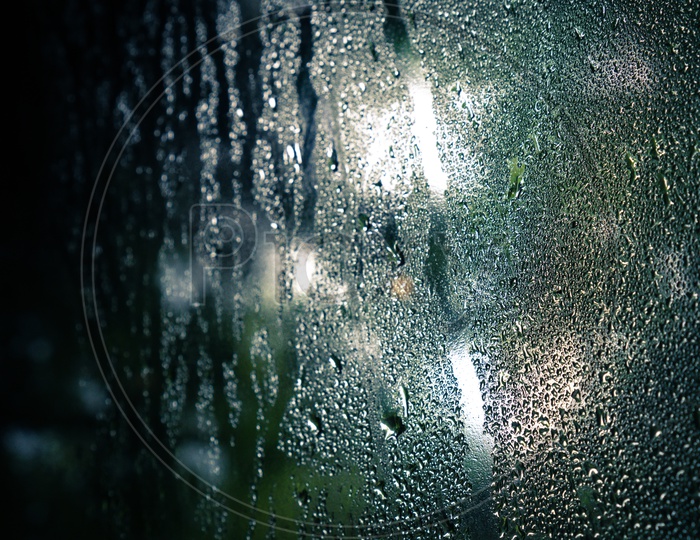 Close up of drops on glass , window condensation , and the background for dark text , spray on the window