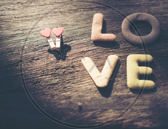 LOVE Word  On an Wooden Table Closeup With Copy Space Forming a Template For Valentine's Day
