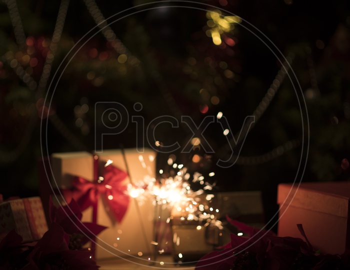 Christmas Or New Year Template Background With Gifts , Decorated tree And Sparking  Firework Stick