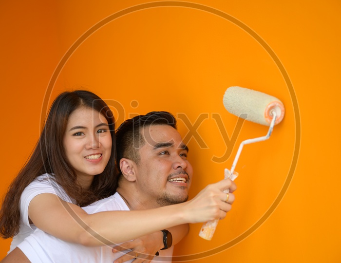 Lovely Couple Painting  a Wall  and Enjoying
