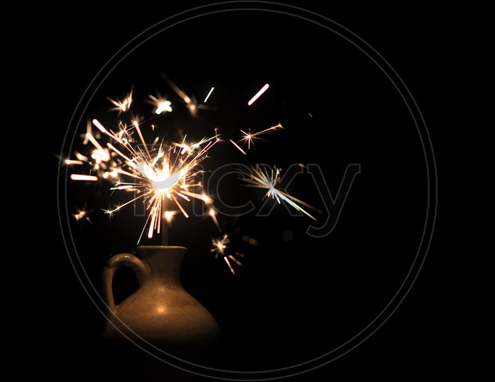 burning sparkler light In a Vase On Isolated Black Background