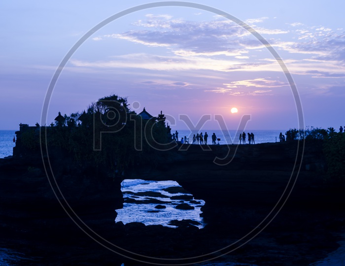 Silhouette Of Tourists  Over Sunset at Batu Bolong & Tanah Lot - Bali, Indonesia