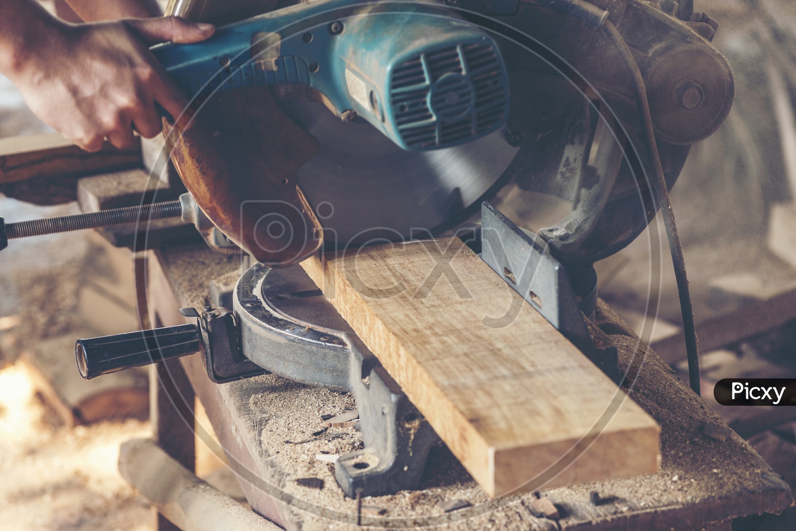 Close up of a Carpenter's work table with different tools and wood cutting stand, vintage filter image