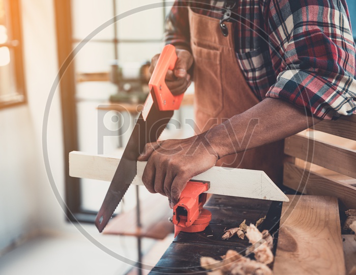 Carpenter hands working on woodworking machines in carpentry shop