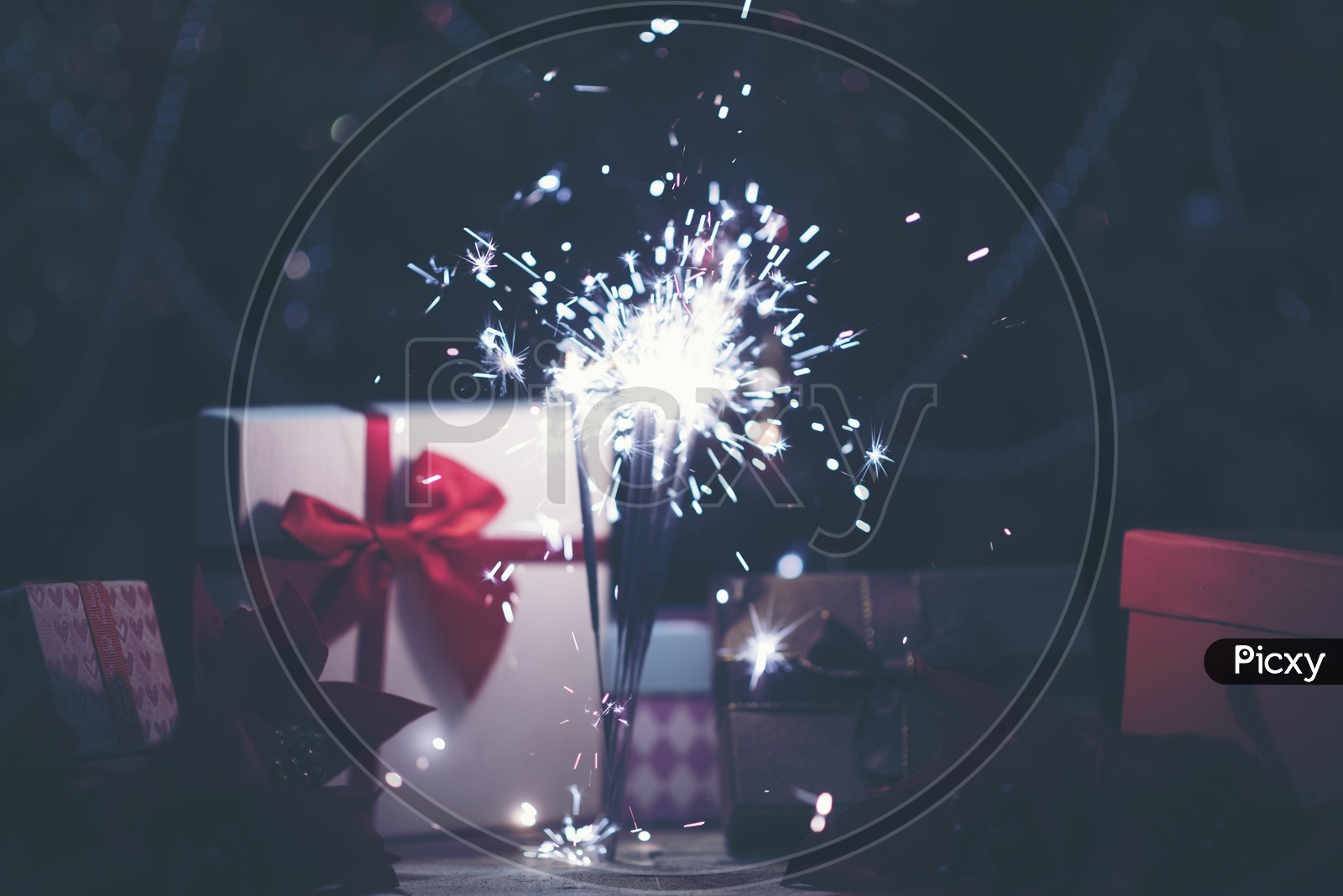 Sparkler Light And Christmas Gift Boxes With Bokeh Background
