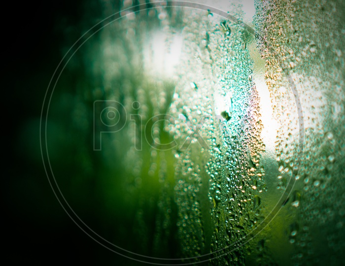 Close up of glass with water droplets and cold vapor, green vintage tone