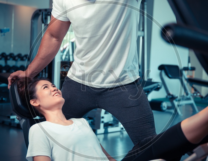 Young Asian Couple Exercising  In a Gym For Fitness