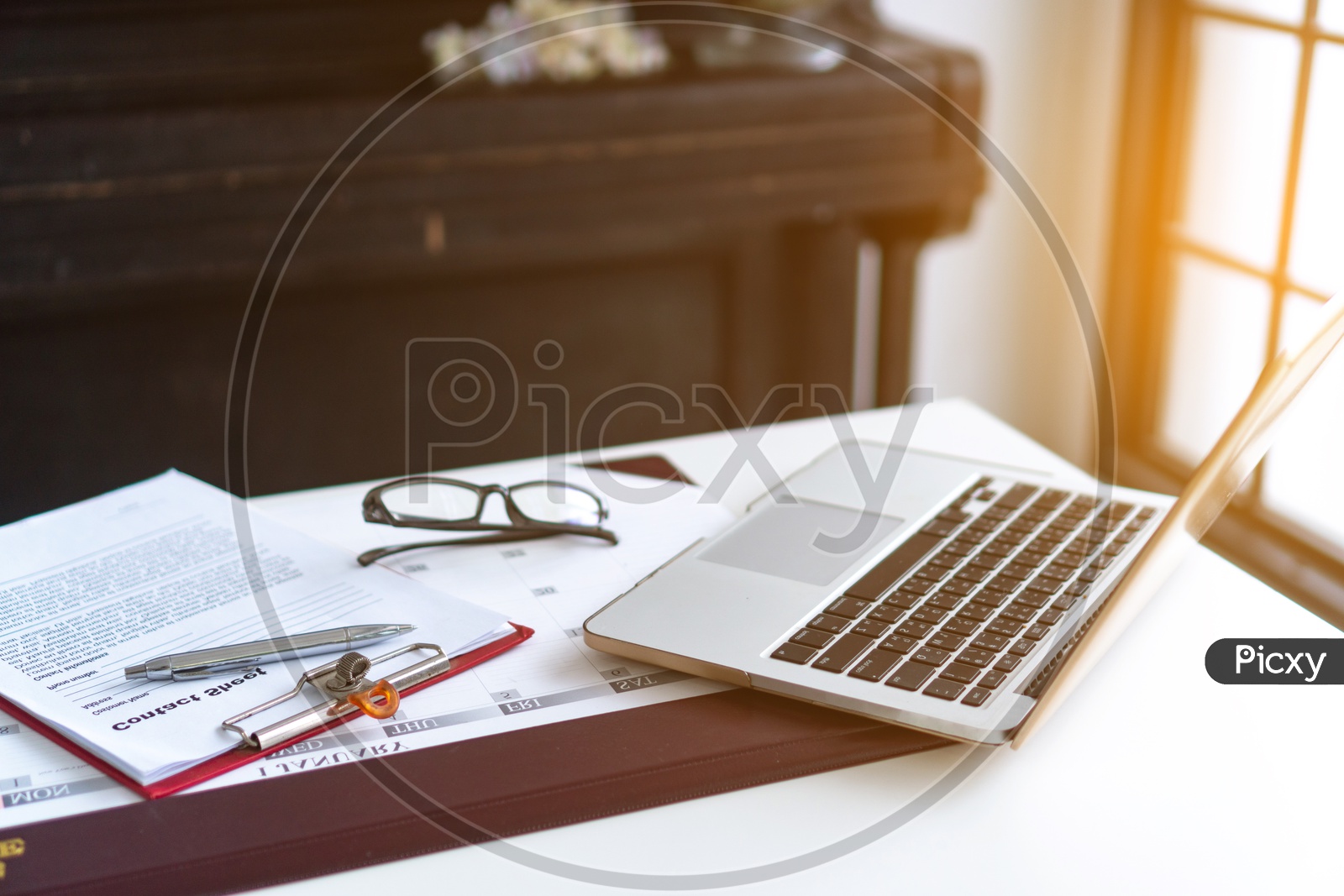 Image of Business laptop, glasses, business schedule on the table