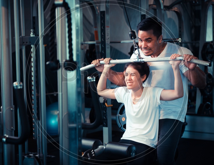 Young Asian Couple Exercising  In a Gym For Fitness