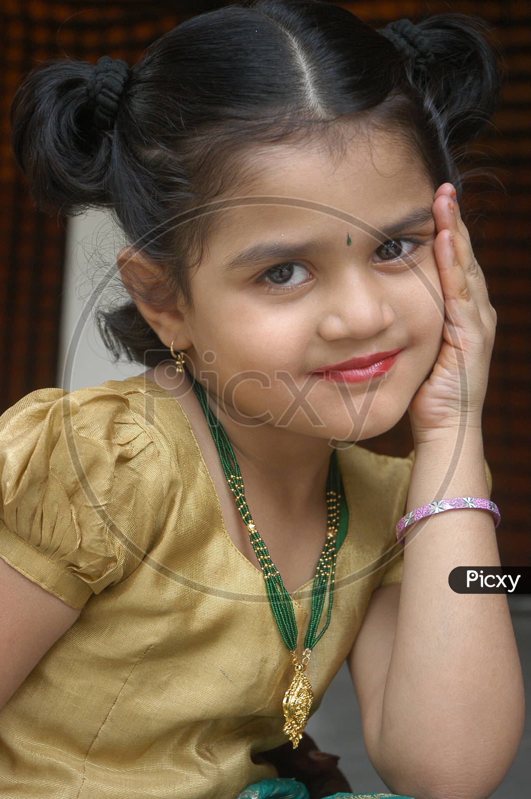 Indian little girl posing wearing lipstick