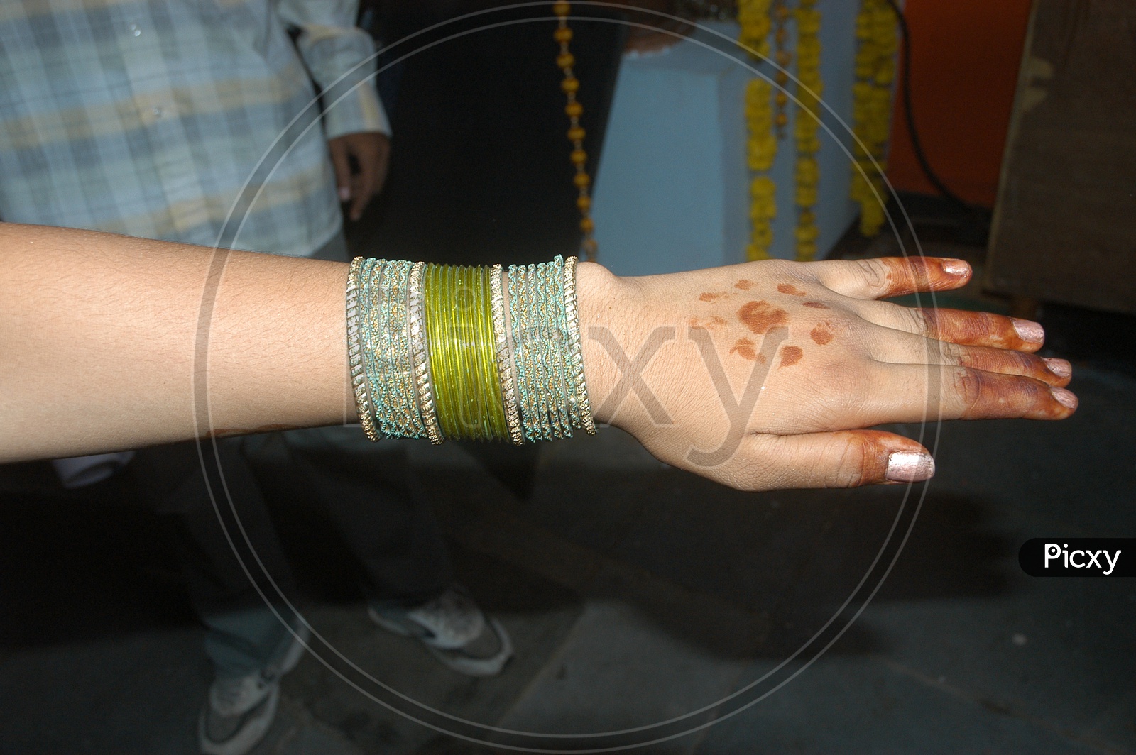 Indian woman's hand with bangles and mehendi