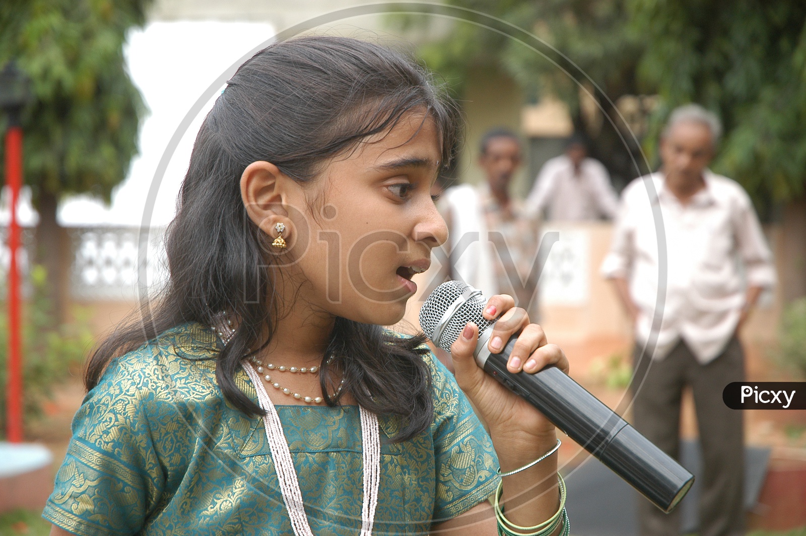 Indian little girl singing on the mic
