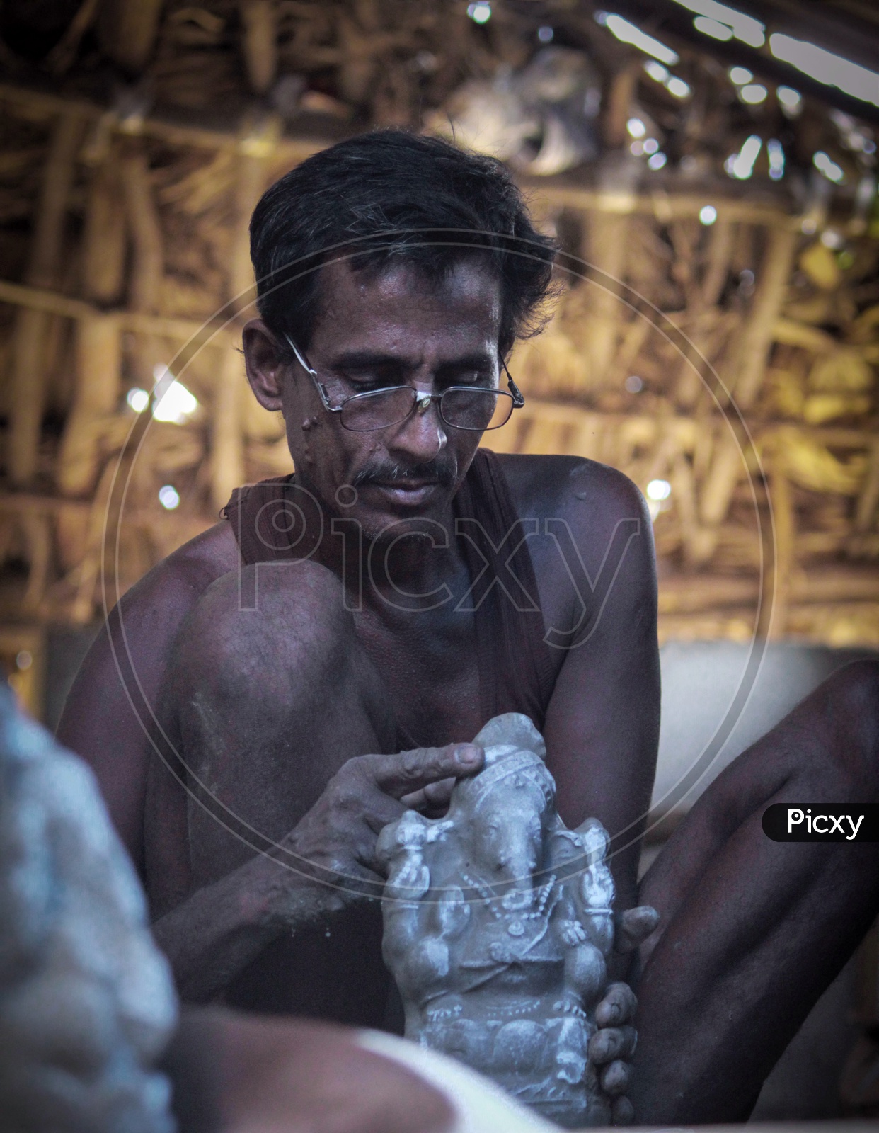 Man in making ganesh idol.