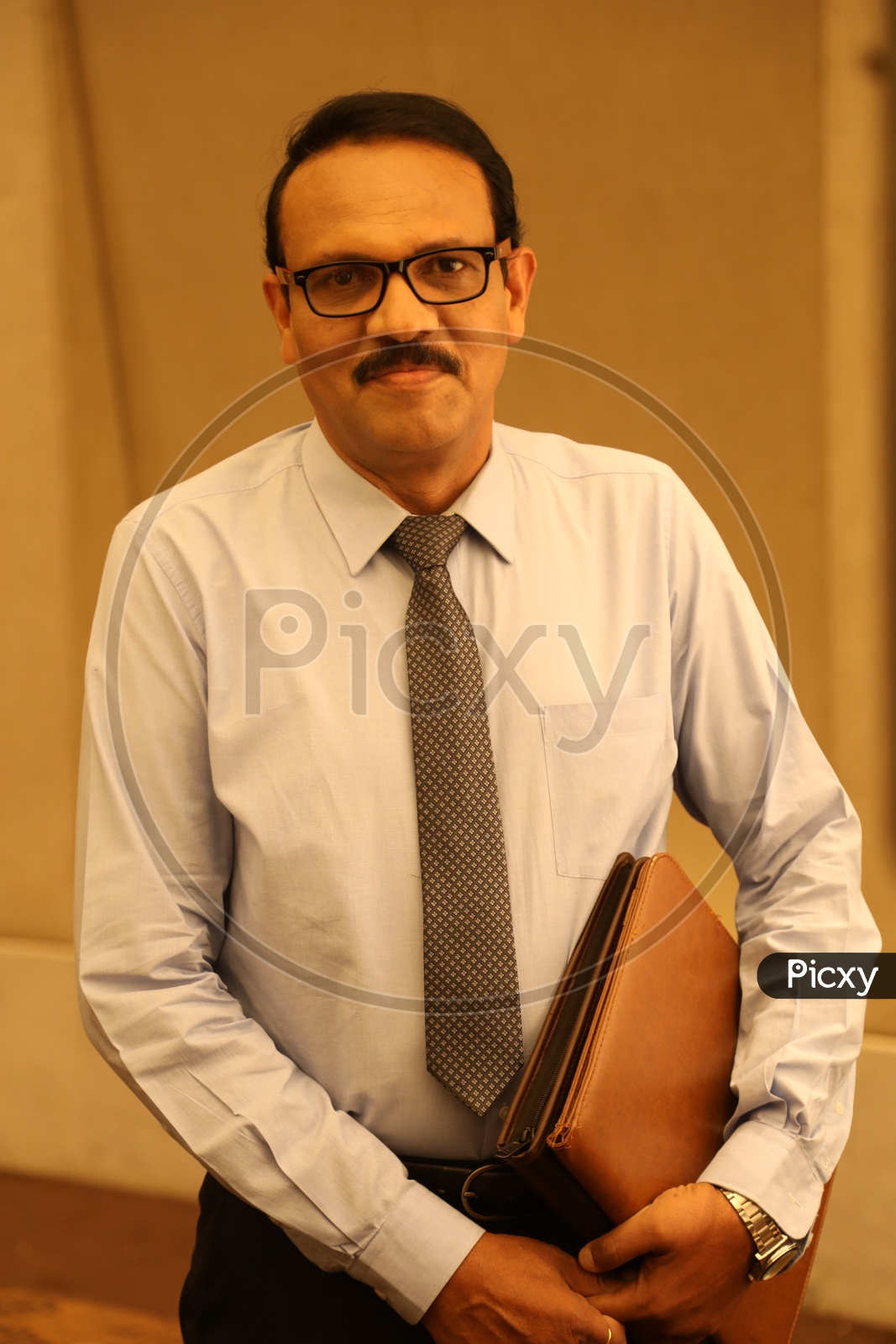 Indian middle aged man with an office file