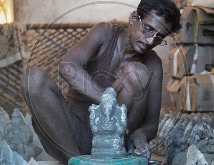 A Man making the ganesh idol.