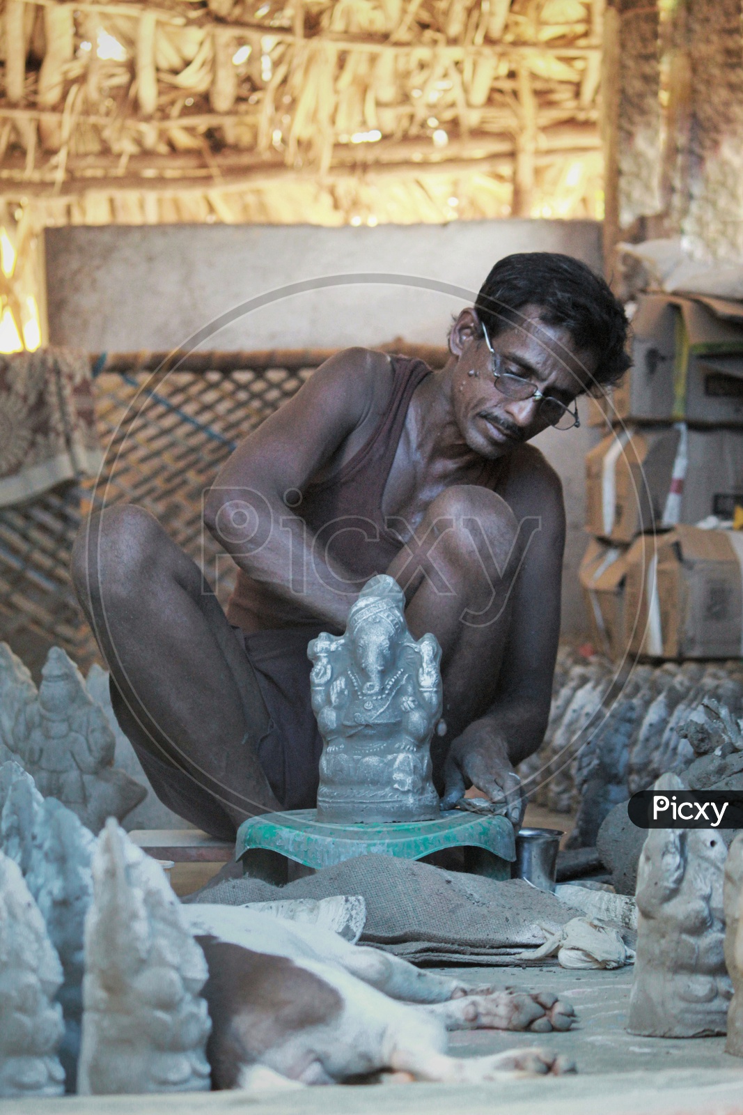 A Man making the ganesh idol.