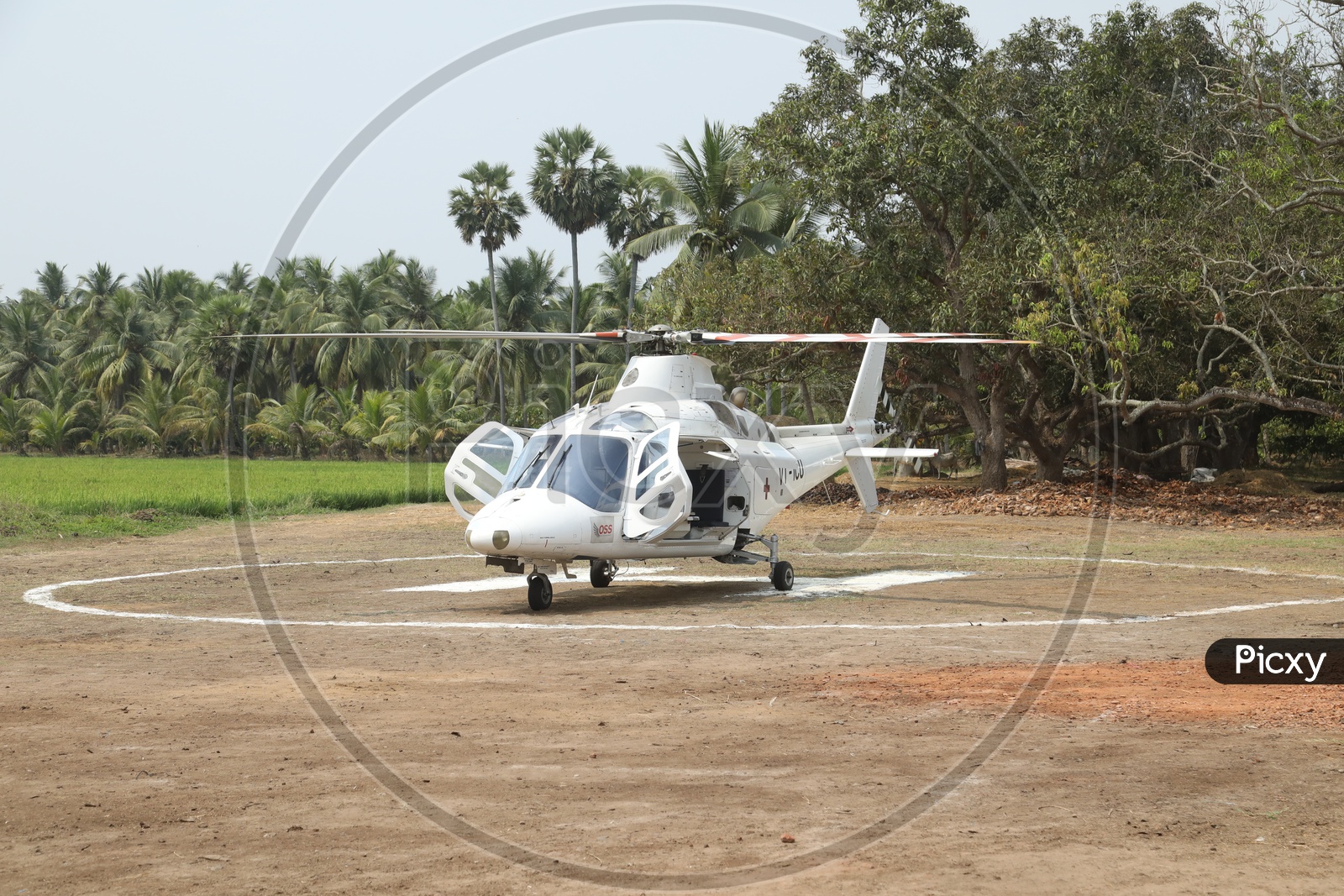 A Helicopter on Helipad with Agriculture Fields in Background