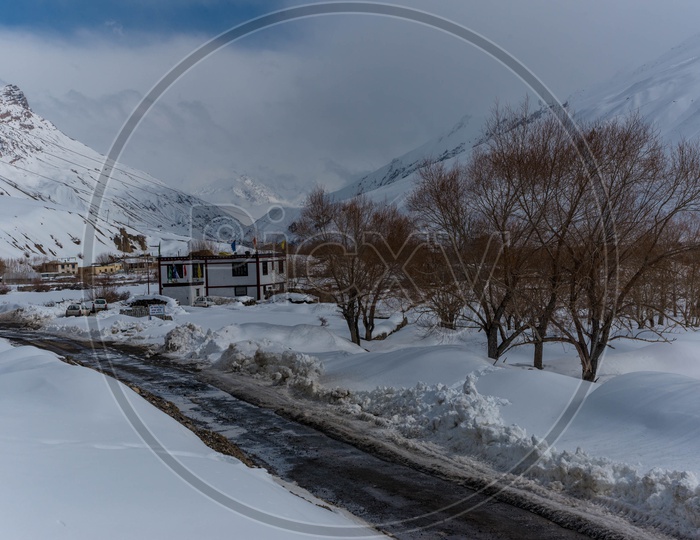 Snow covered road in Spiti Valley with Snow Capped Mountains