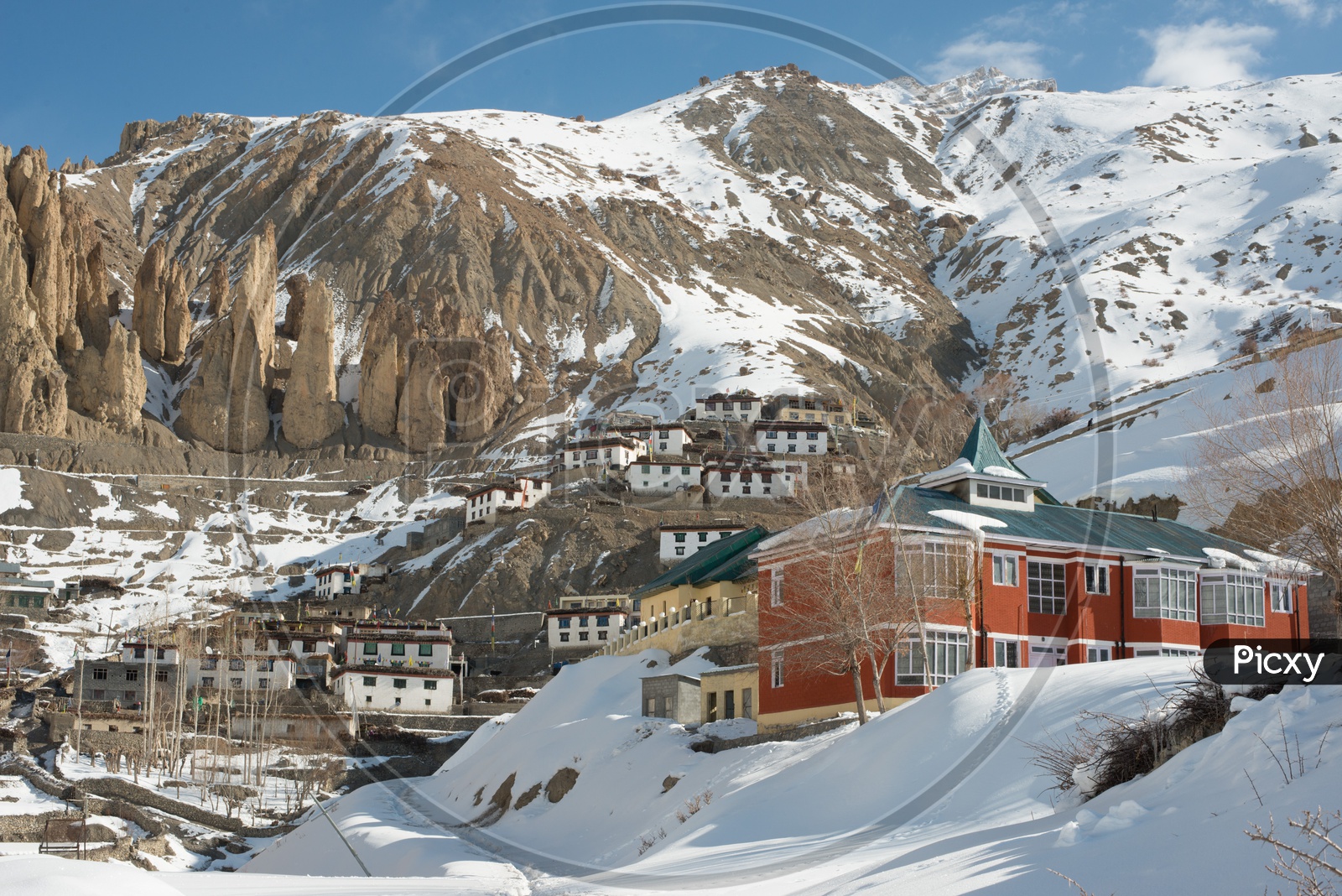 A Village in Spiti on Mountain Covered in Snow Surrounded by Snowy Himalayan Mountain Peaks in Winter