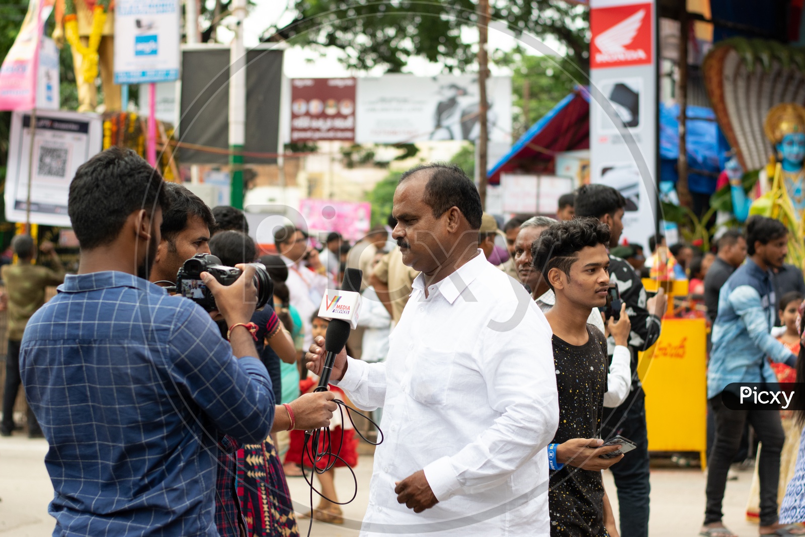 Man giving interview to Journalists or Media at Khairatabad Ganesha Temple