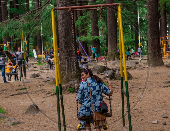 Indian Mother with her Daughter on Swing in Van Vihar National Park at Manali