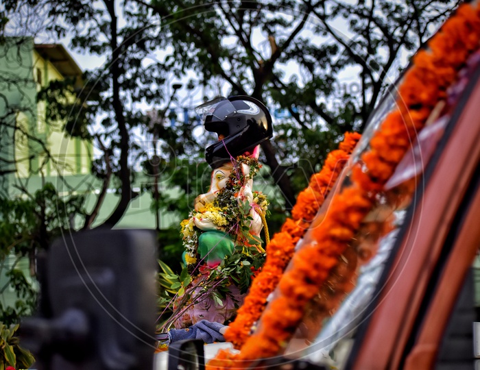 Helmet To Lord Ganesh Idol During Procession