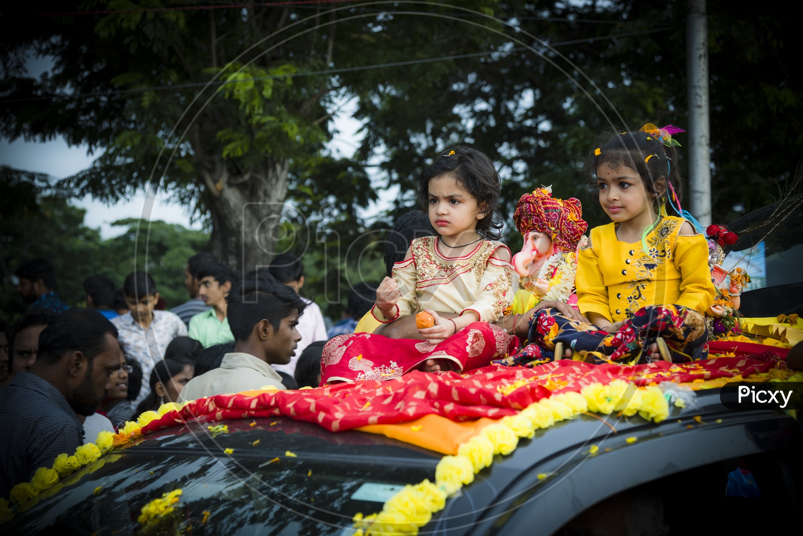 Cute little Angels with cute Ganesh on Car rooftop