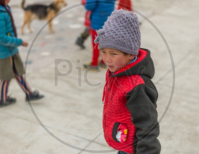 A Himalayan Kid Playing in a Monastery