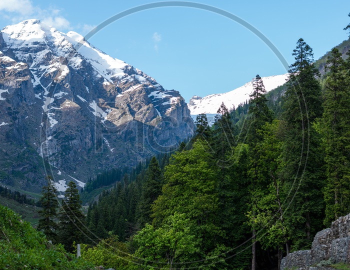 A scenic view of snow capped mountains at Hamta Pass Trek