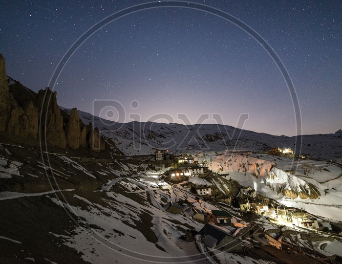 Night View of Spiti Village in Snow with Stars in Sky