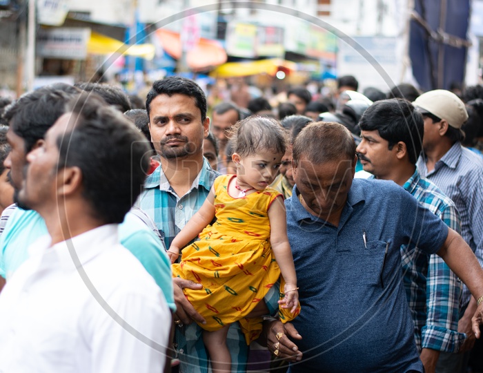 Indian Father with his Child in a Queue waiting at Khairatabad Ganesh Temple
