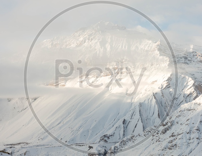 Houses in Snow Cover with Snowy Himalayan Mountains in Background