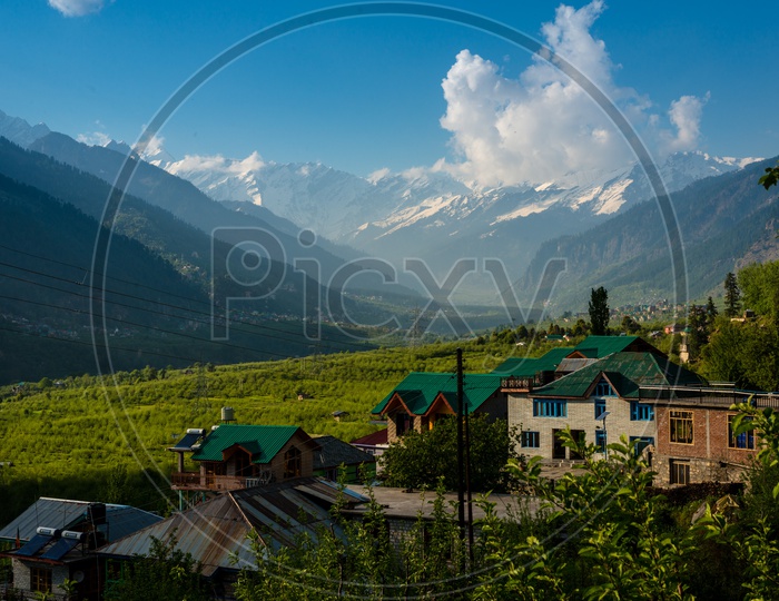 Landscape of colorful houses with himalayas in background