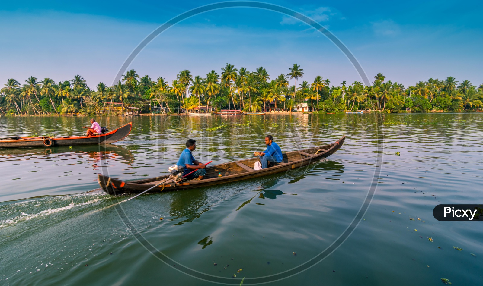 Indian men traveling on a boat on the backwaters