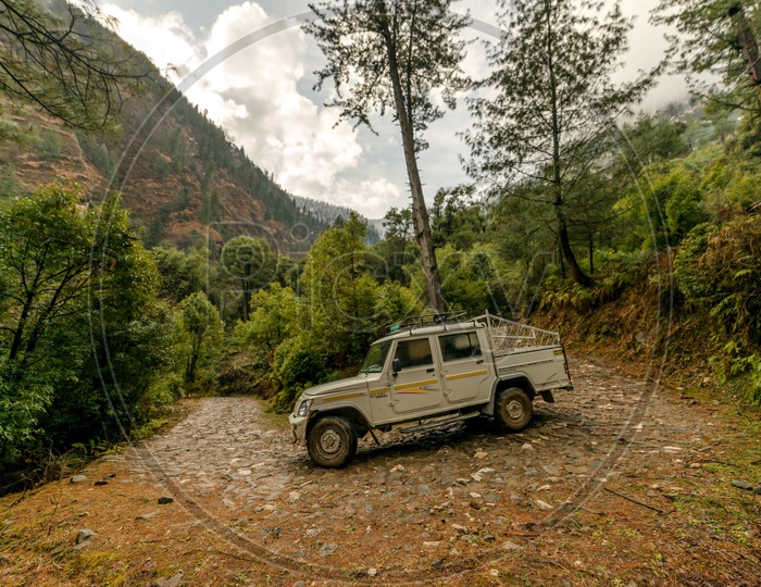 Vehicle on High altitude road in Himalayas with Mountains in Background