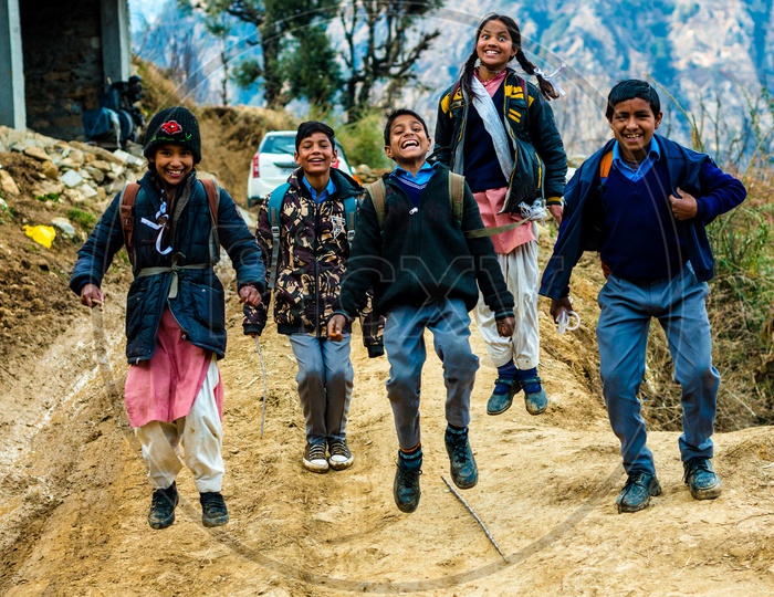 Portrait of Indian School Kids Jumping and Smiling on the Street