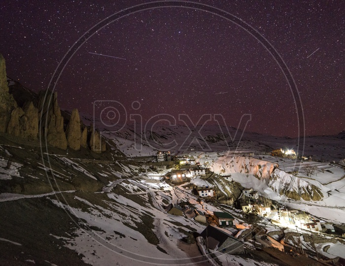 Night View of Spiti Village Covered in Snow with Stars in Sky