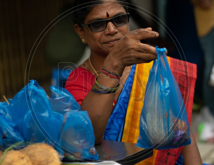 Indian Old Woman Selling Pooja Items at Khairatabad Ganesha Temple
