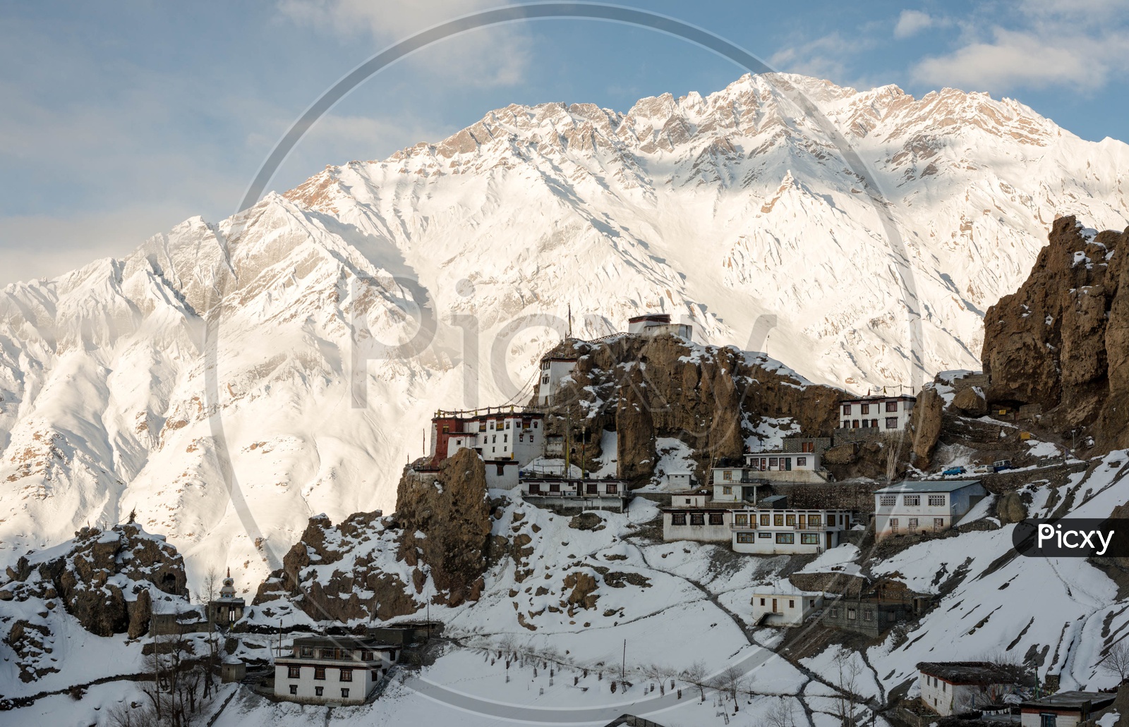 Dhankar Village on Mountains in Winter Season with Snow Capped Himalayan Mountain Range in Background