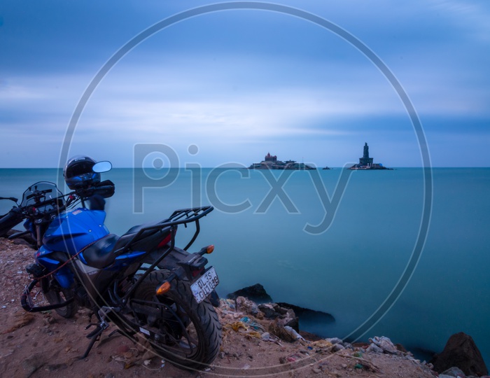 A Bike parked along the shore of Vivekananda Rock Temple
