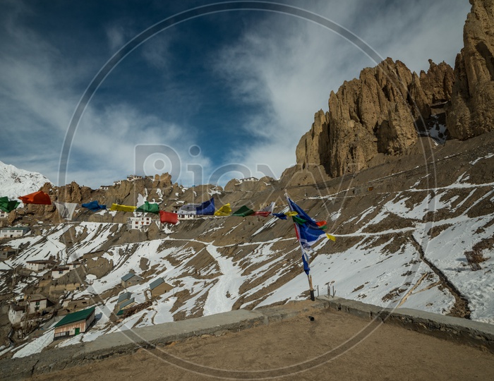 Tibetian Flags in Foreground with Spiti Village Covered in Snow in Winter