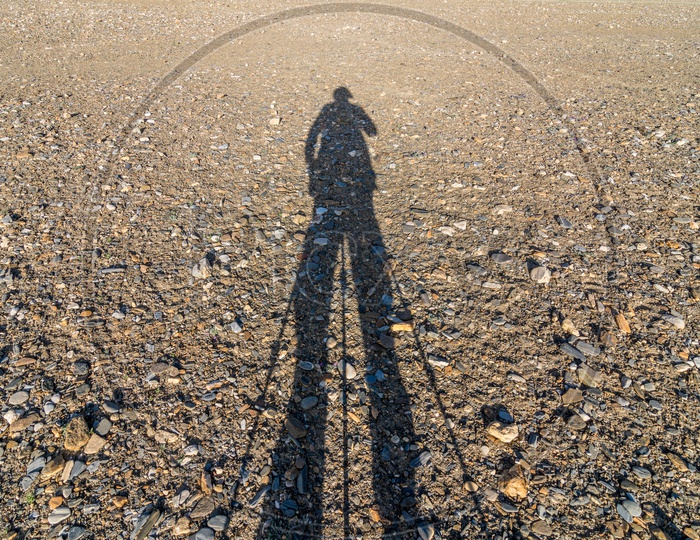 Shadow of a man holding tripod