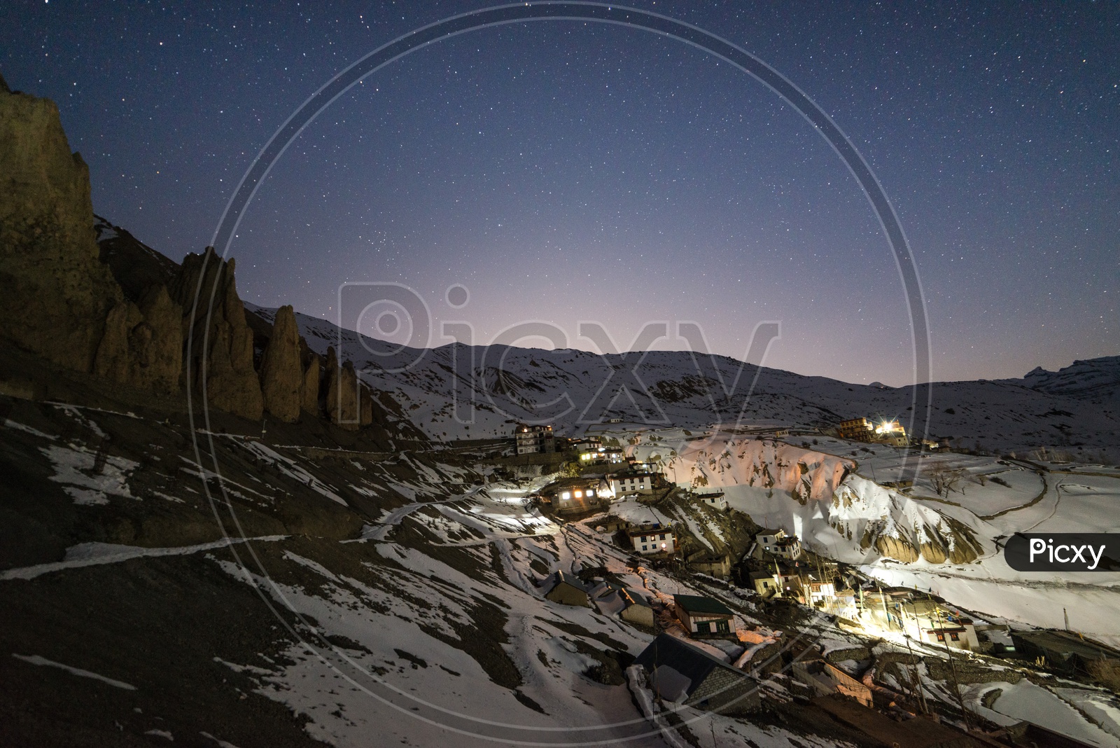 Night View of Spiti Village in Snow with Stars in Sky