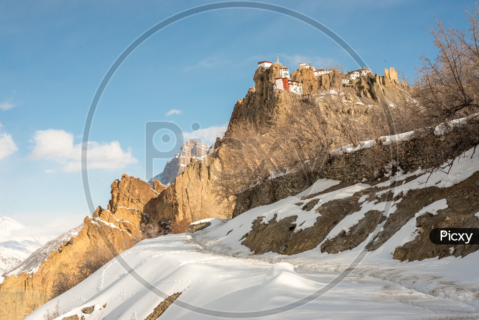Dhankar Monastery on Mountain in Snow with Clouds in Sky