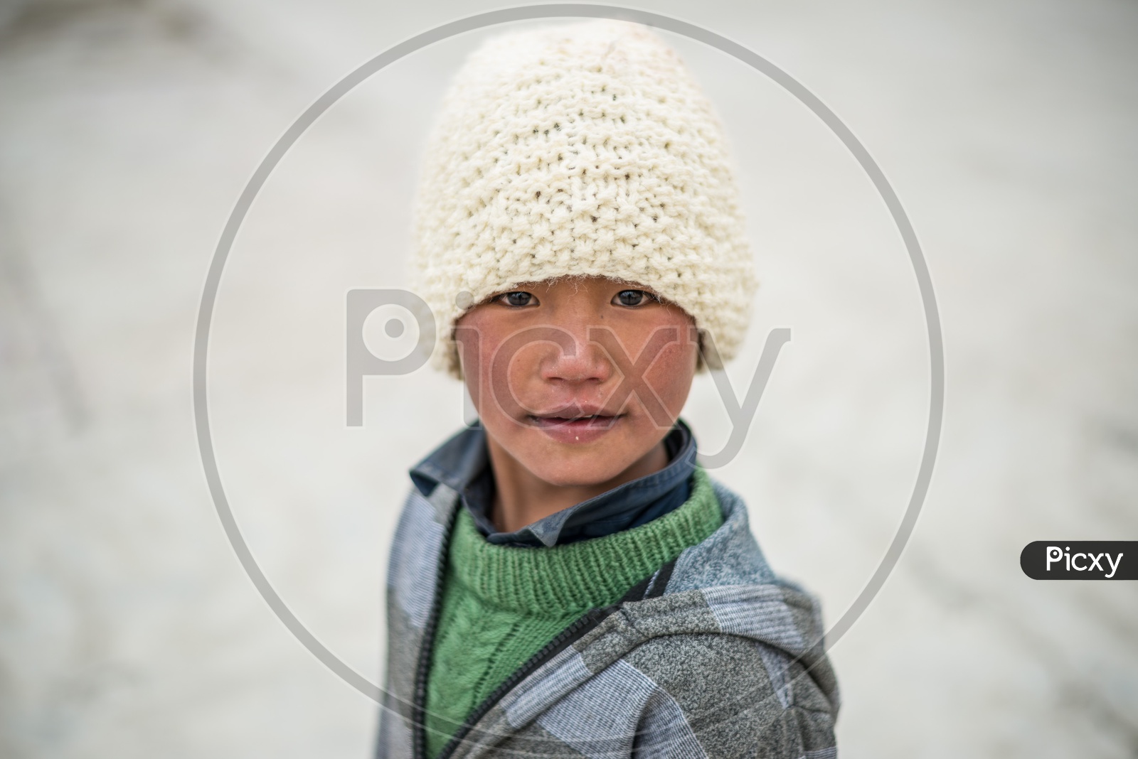 Portrait of Himalayan Kid with Handmade Cap on Head